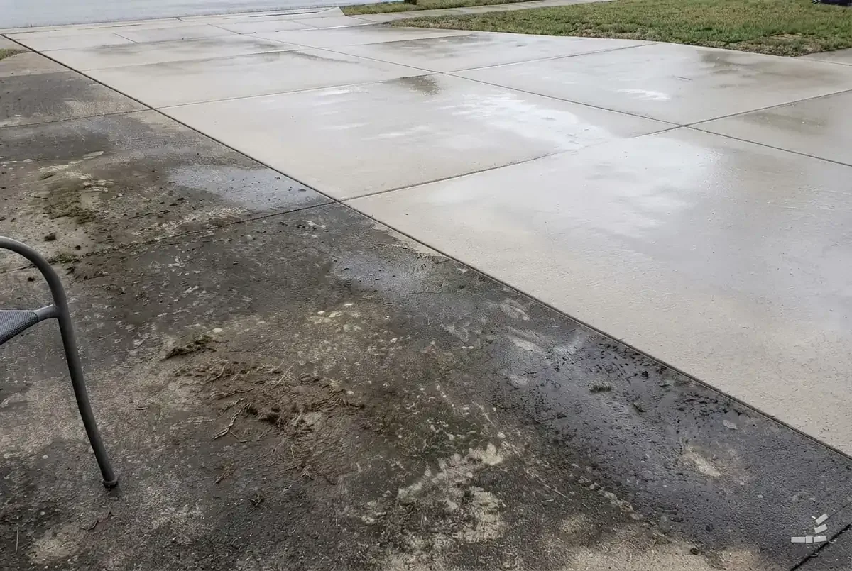 Photograph-style concrete patio slab half cleaned along a diagonal — second view